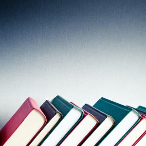 Red, black and green books in a library