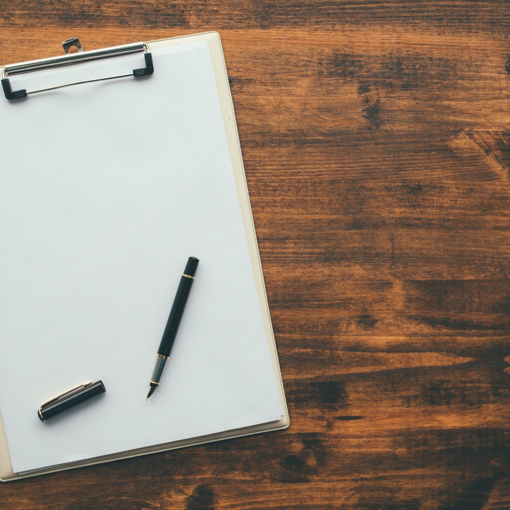 Overhead view of blank clipboard note pad paper with pen Mike Bonem
