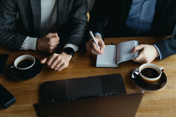 Two young businessman having a successful meeting at restaurant.